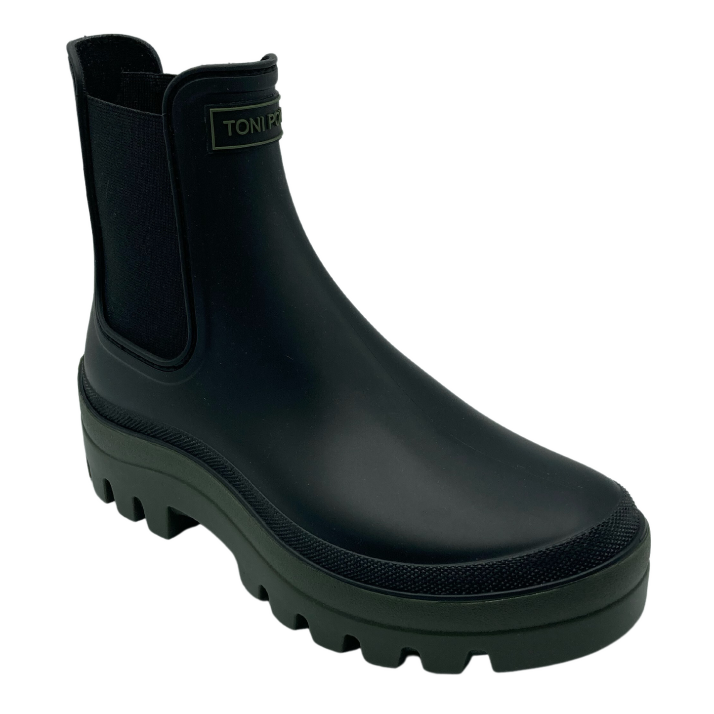 45 degree angled view of black chelsea boot with khaki rubber sole and elastic sides