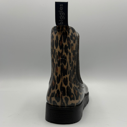 A single rain boot shown from the back, featuring a glossy leopard print pattern in brown, beige, and black, with a black pull tab