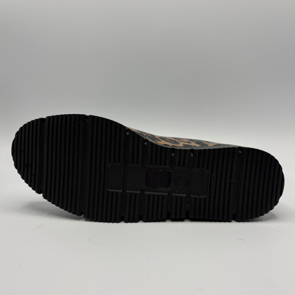The black ribbed sole of a boot with a brown and black patterned upper, shown from a top-down view on a light gray background.