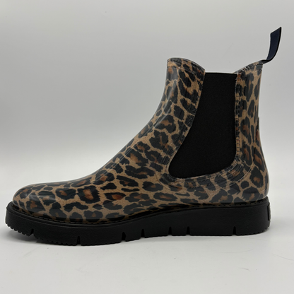 A single Chelsea-style ankle boot with a brown and black leopard print upper and a black elastic side gore, shown in profile against a light gray background.