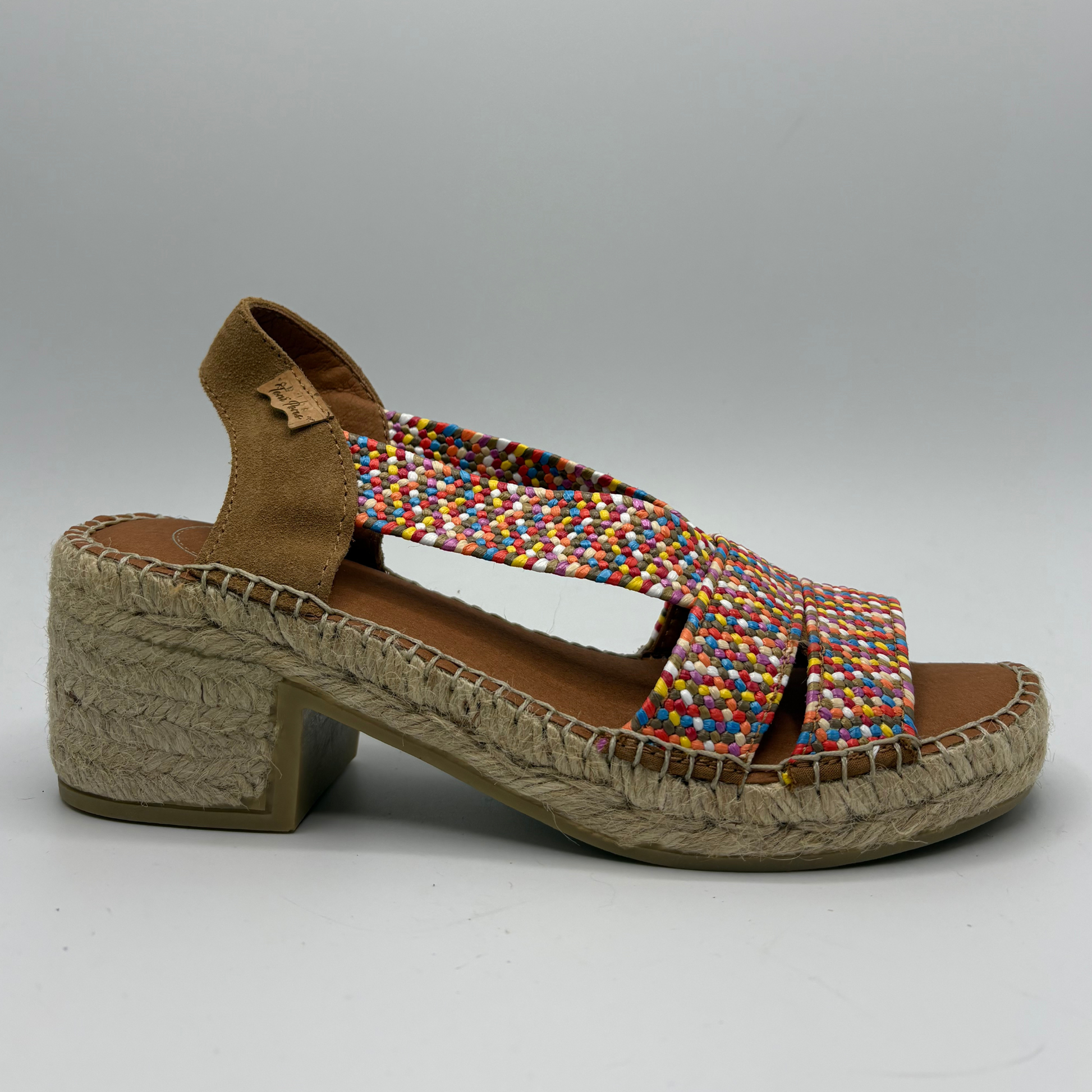 Multicoloured woven sandal with a textured sole on a gray background