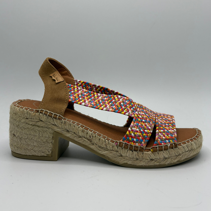 Multicoloured woven sandal with a textured sole on a gray background