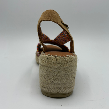 Woven sandal with a textured sole on a white background