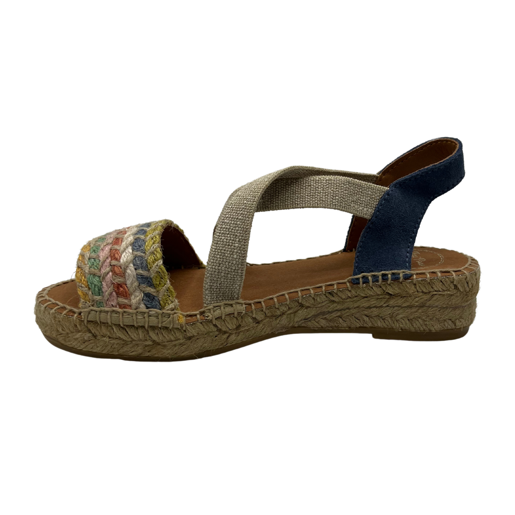 Left facing view of women's espadrille with non-slip rubber bottom and hand stitched details.