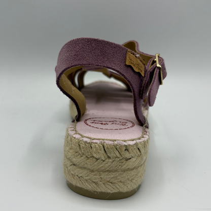 Purple sandal with a textured sole on a white background