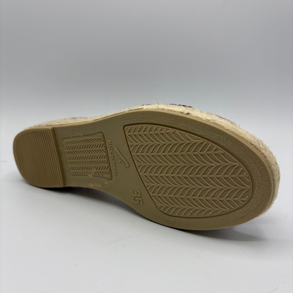 Tan shoe sole with brand logo on a white background