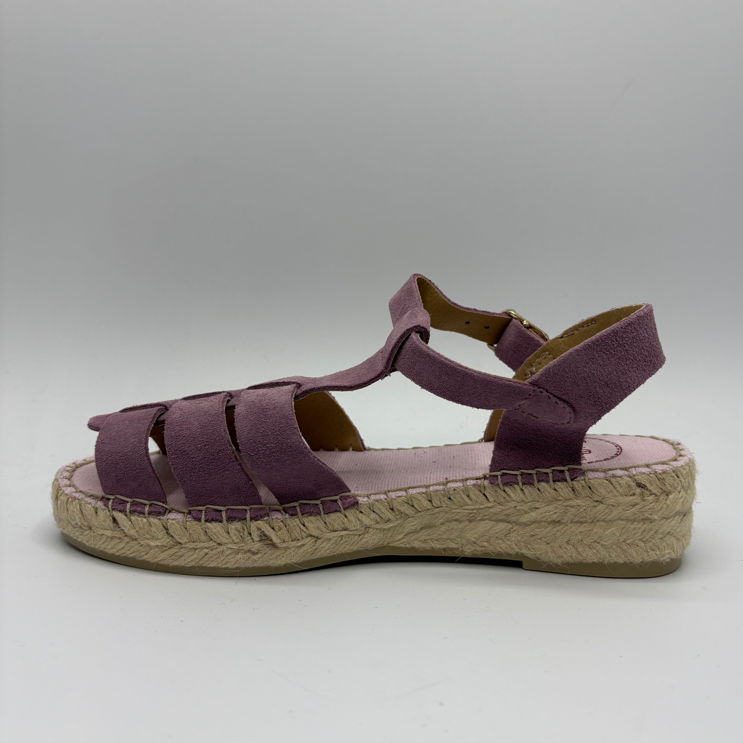 Purple sandal with jute sole on a gray background