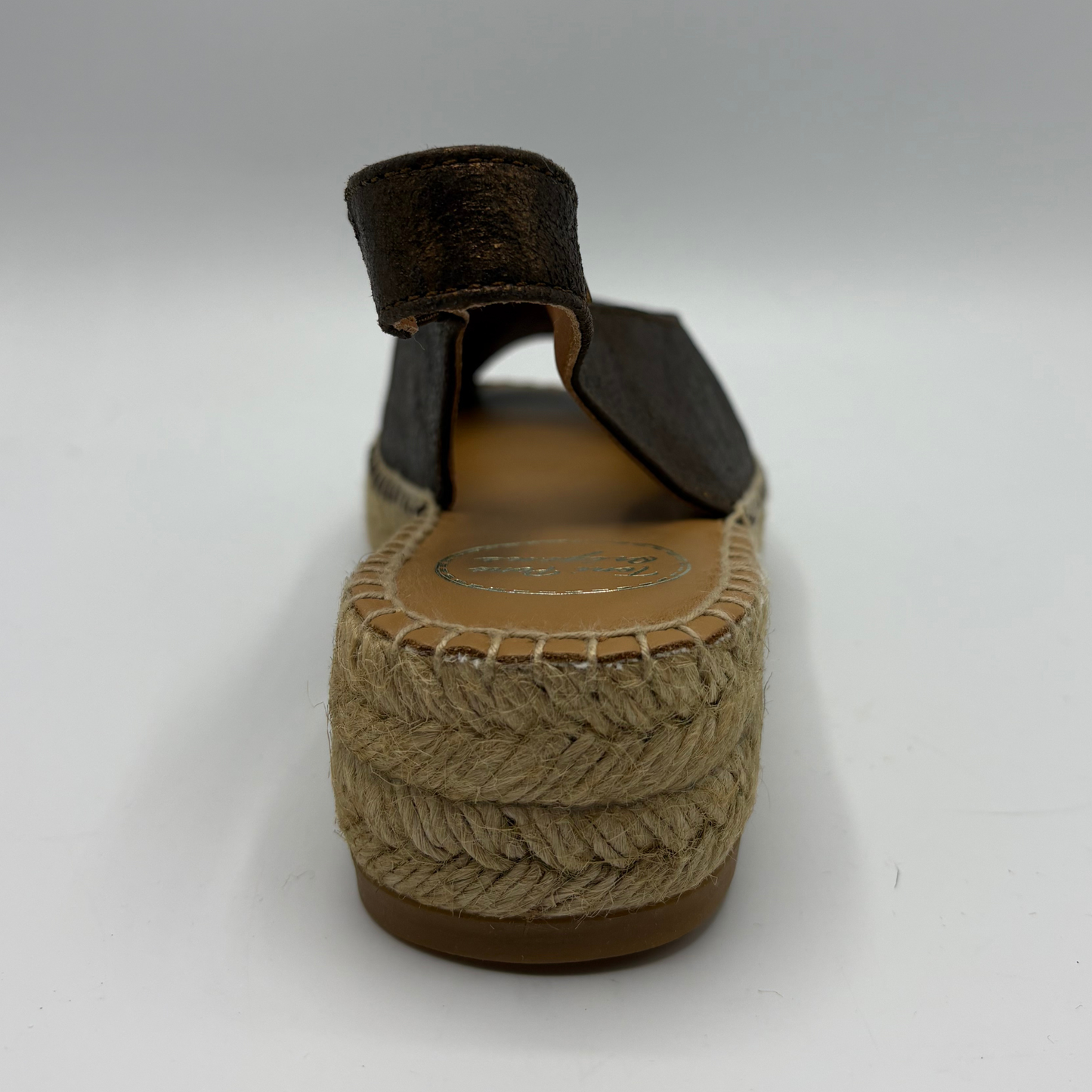 Brown sandal with jute wedge sole on a white background