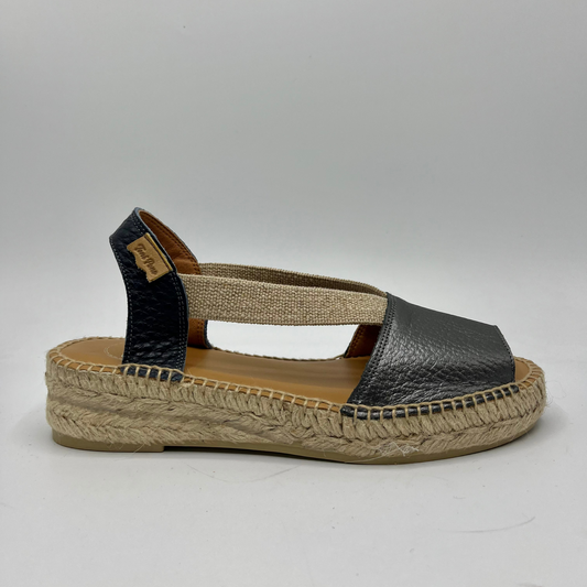 Right facing view of an espadrille soled sandal with elasticated side straps and platinum leather straps.