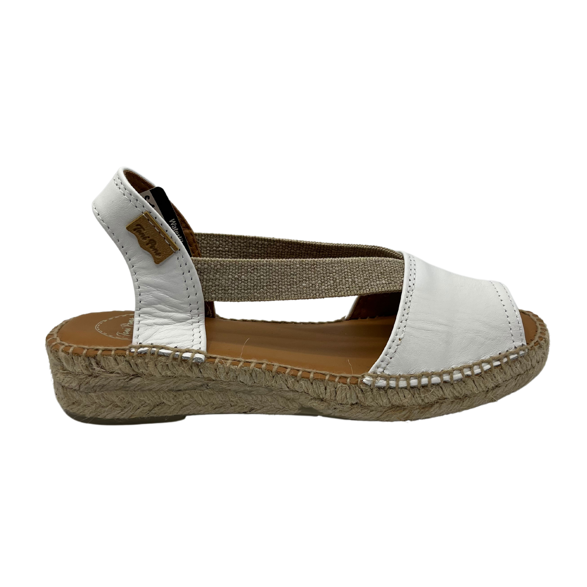 Right facing view of white leather sandal with brown lining and rounded toe
