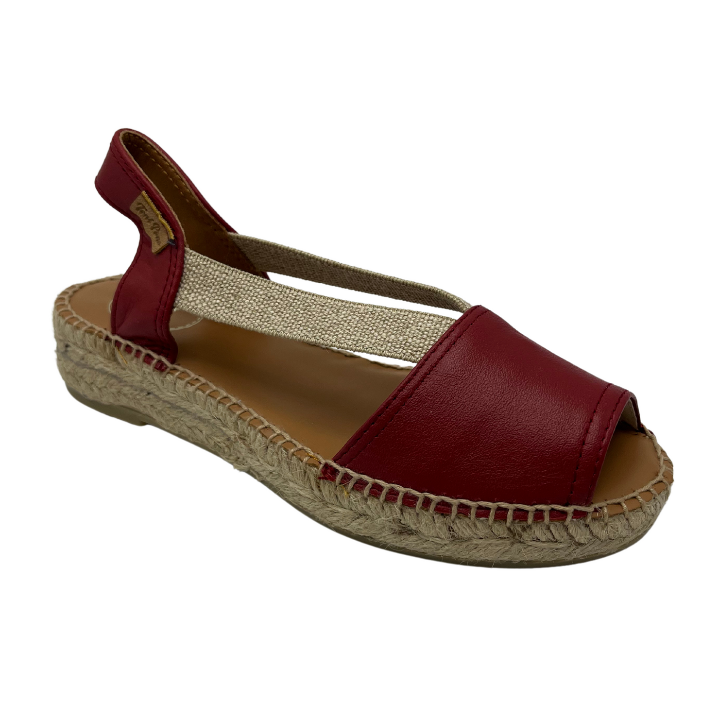 45 degree angled view of red leather sandal with rounded toe and brown lining