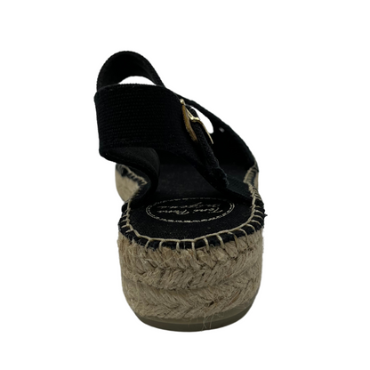 Back facing view of black macrame sandal with beige heel and buckle strap