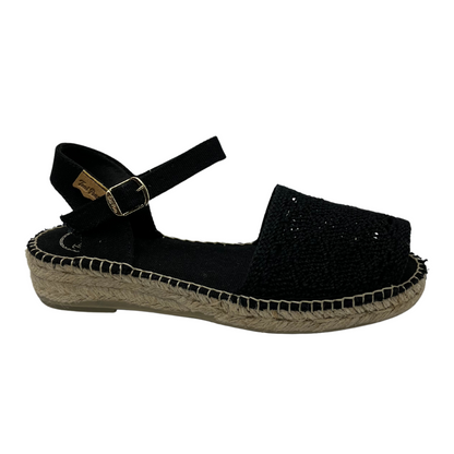 Right facing view of black macrame sandal with buckle ankle strap and flat sole