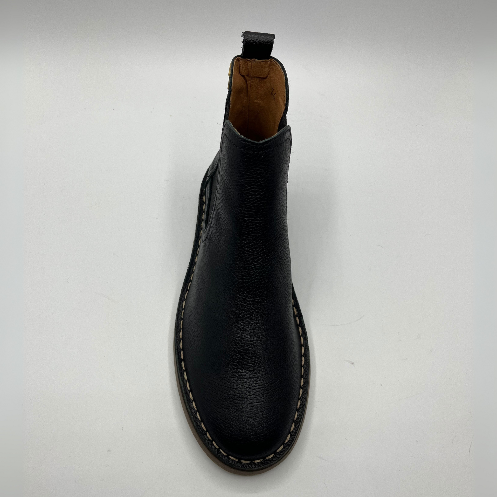 Black leather boot on a white background