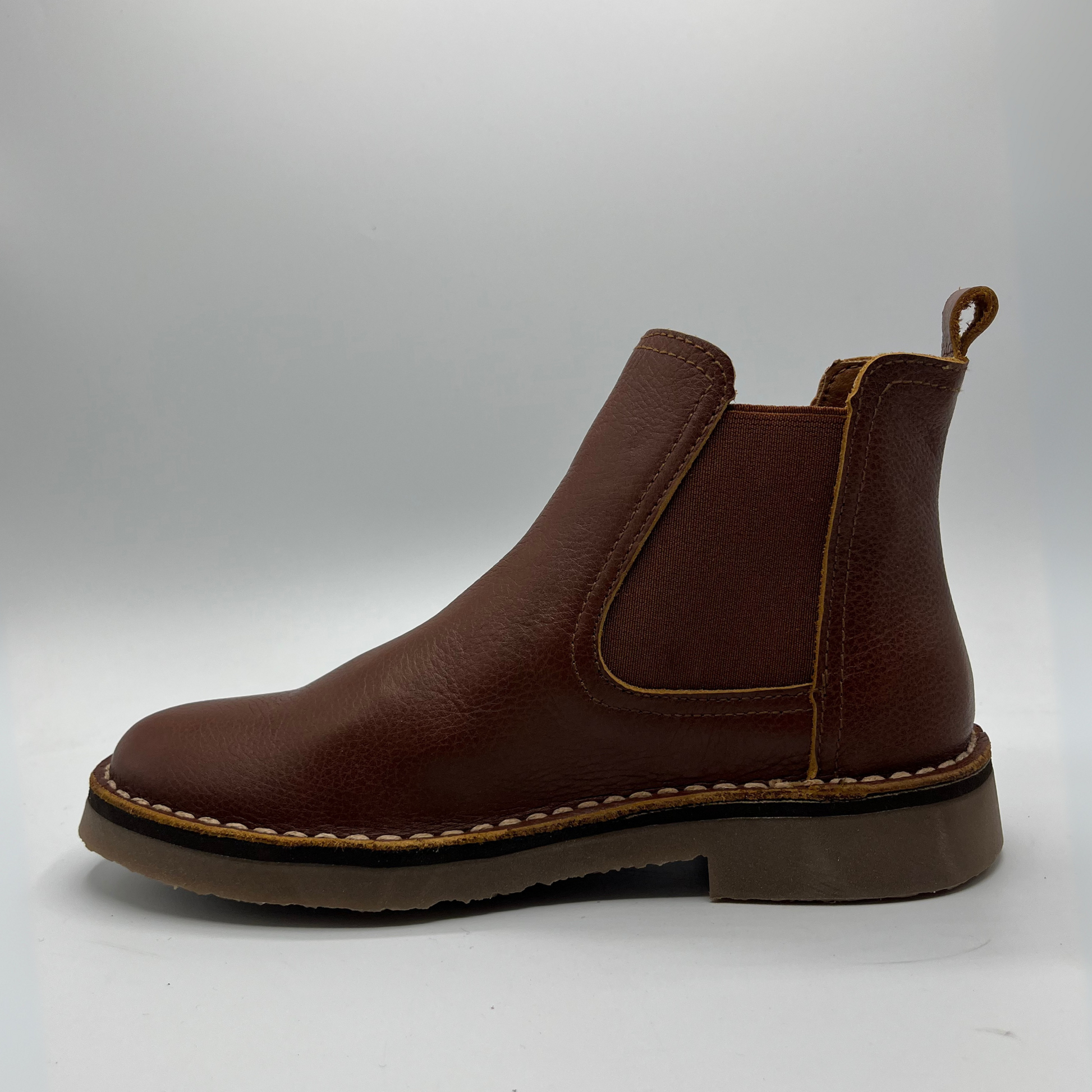 Brown leather boot on a white background