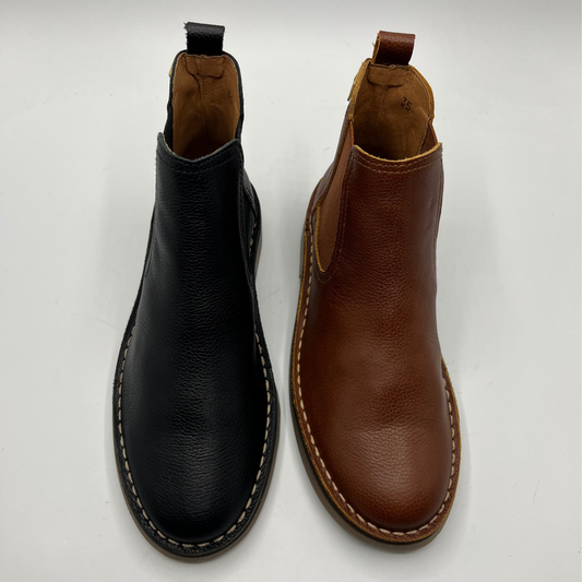Black and brown leather boots on a white background