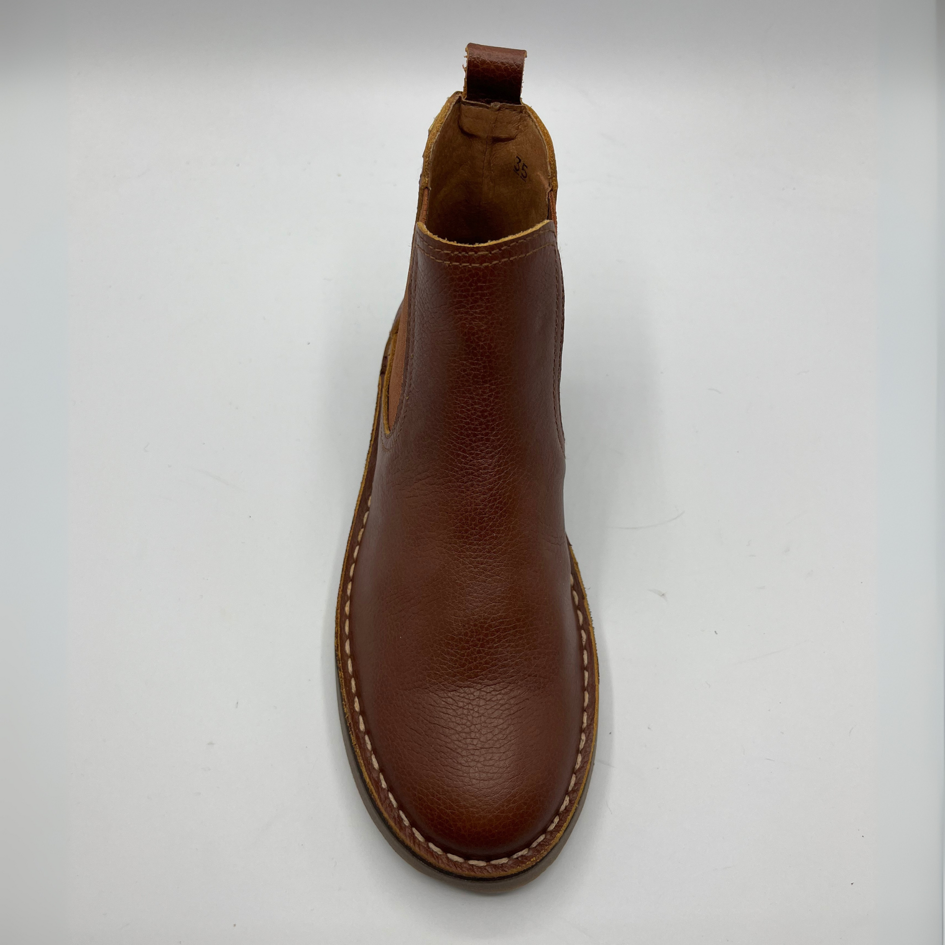 Brown leather boot on a white background