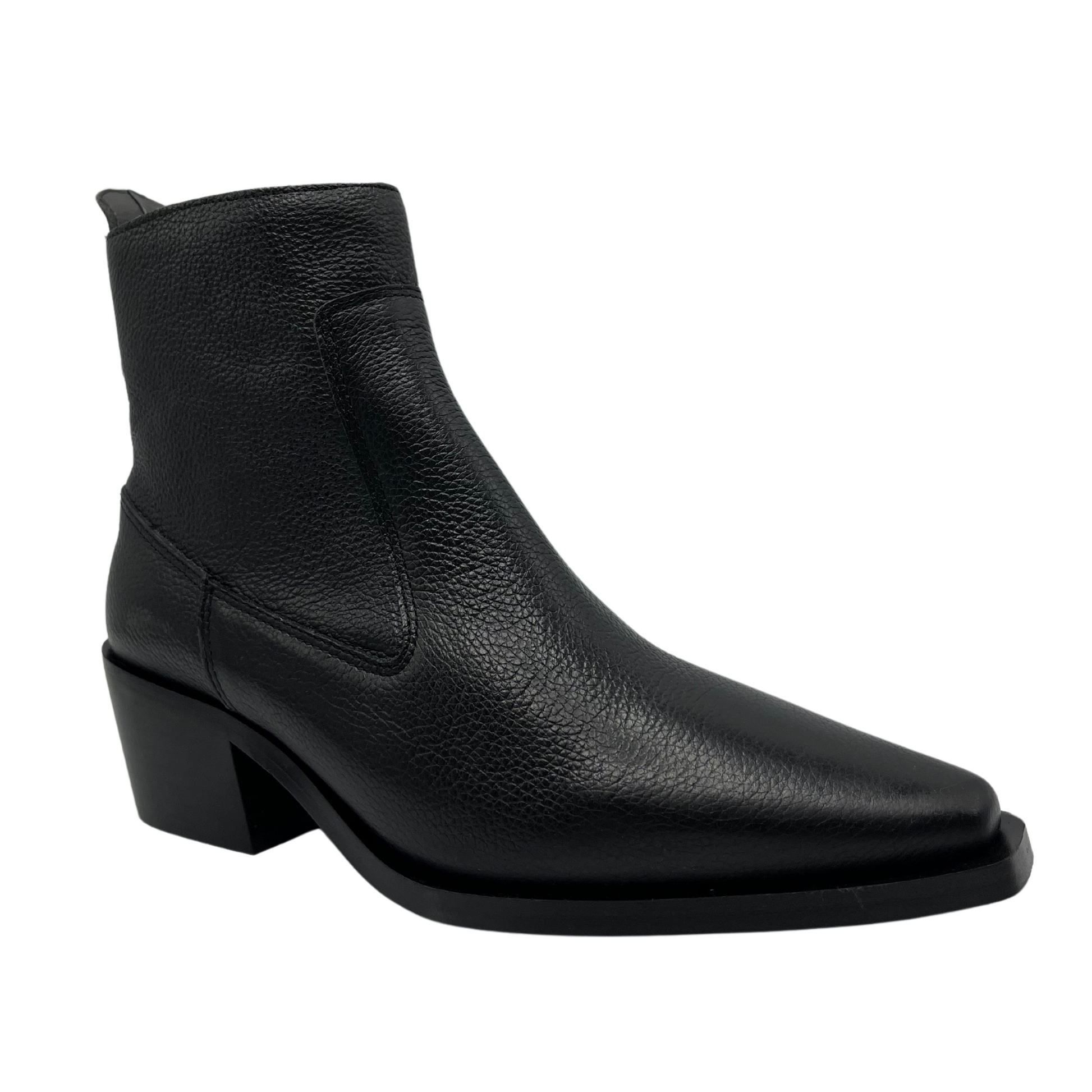 45 degree angled view of black leather ankle boot with pointed toe and block heel