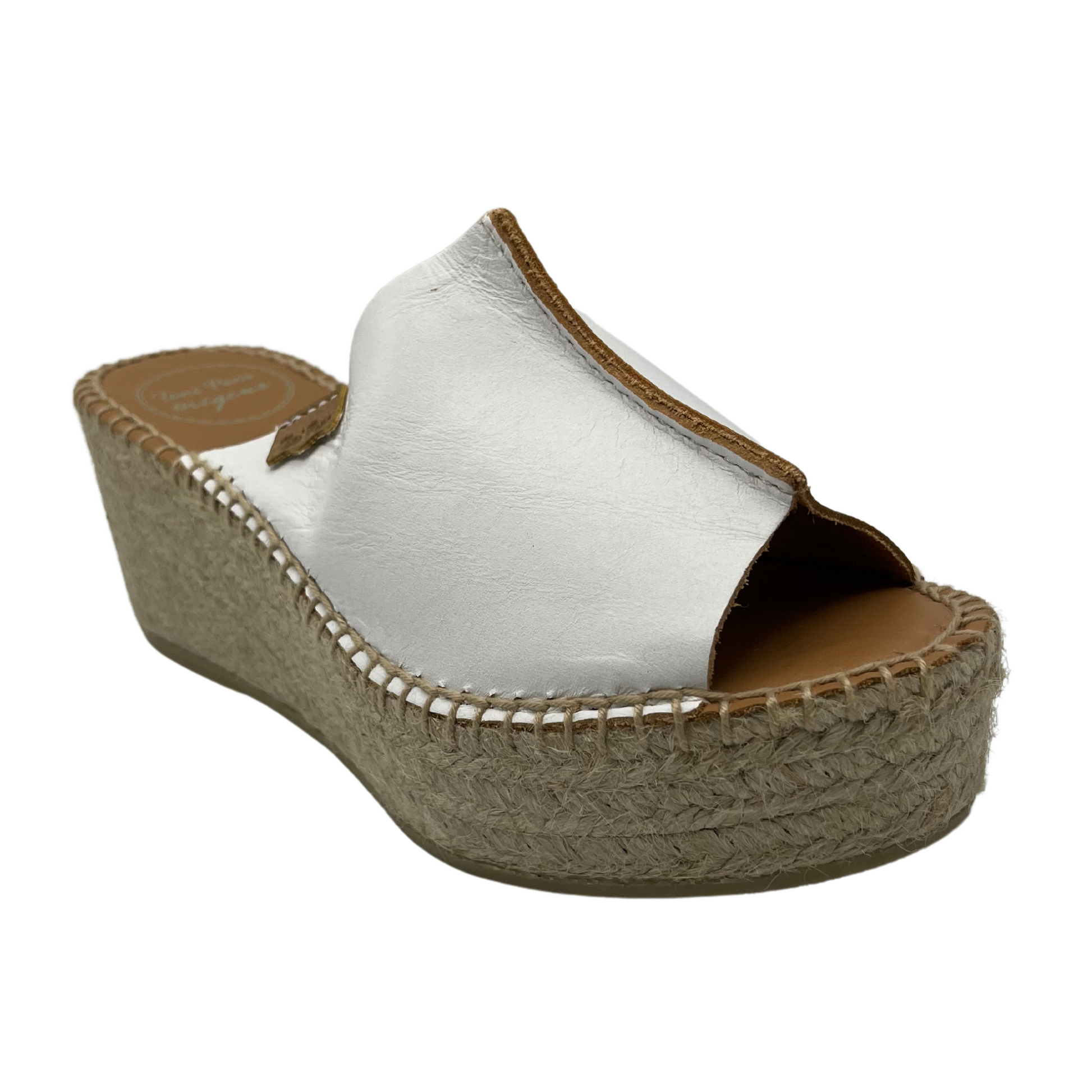 45 degree angled view of white leather wedge espadrille with handstitching around sole