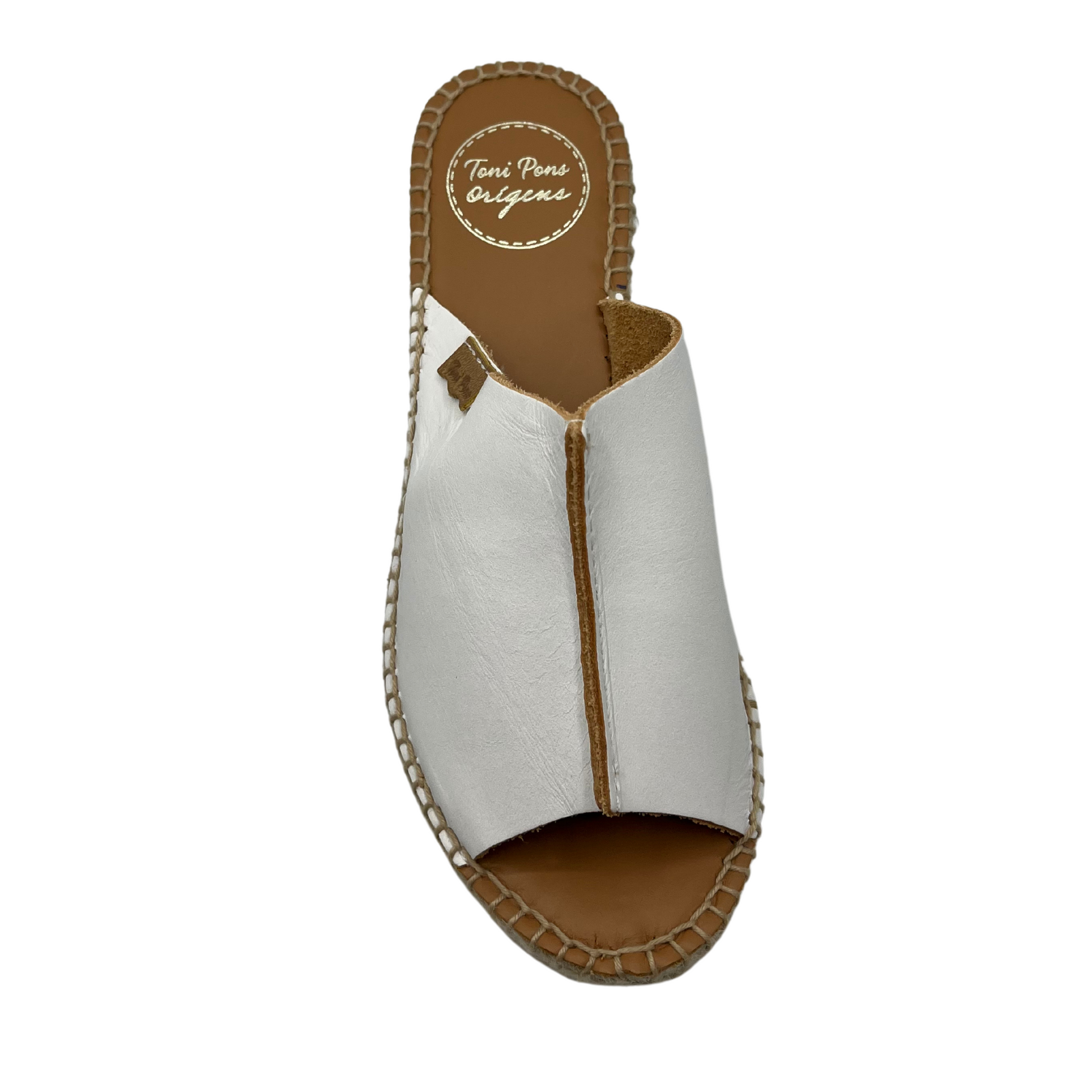 Top view of white leather espadrille with wedge heel and hand stitching around sole