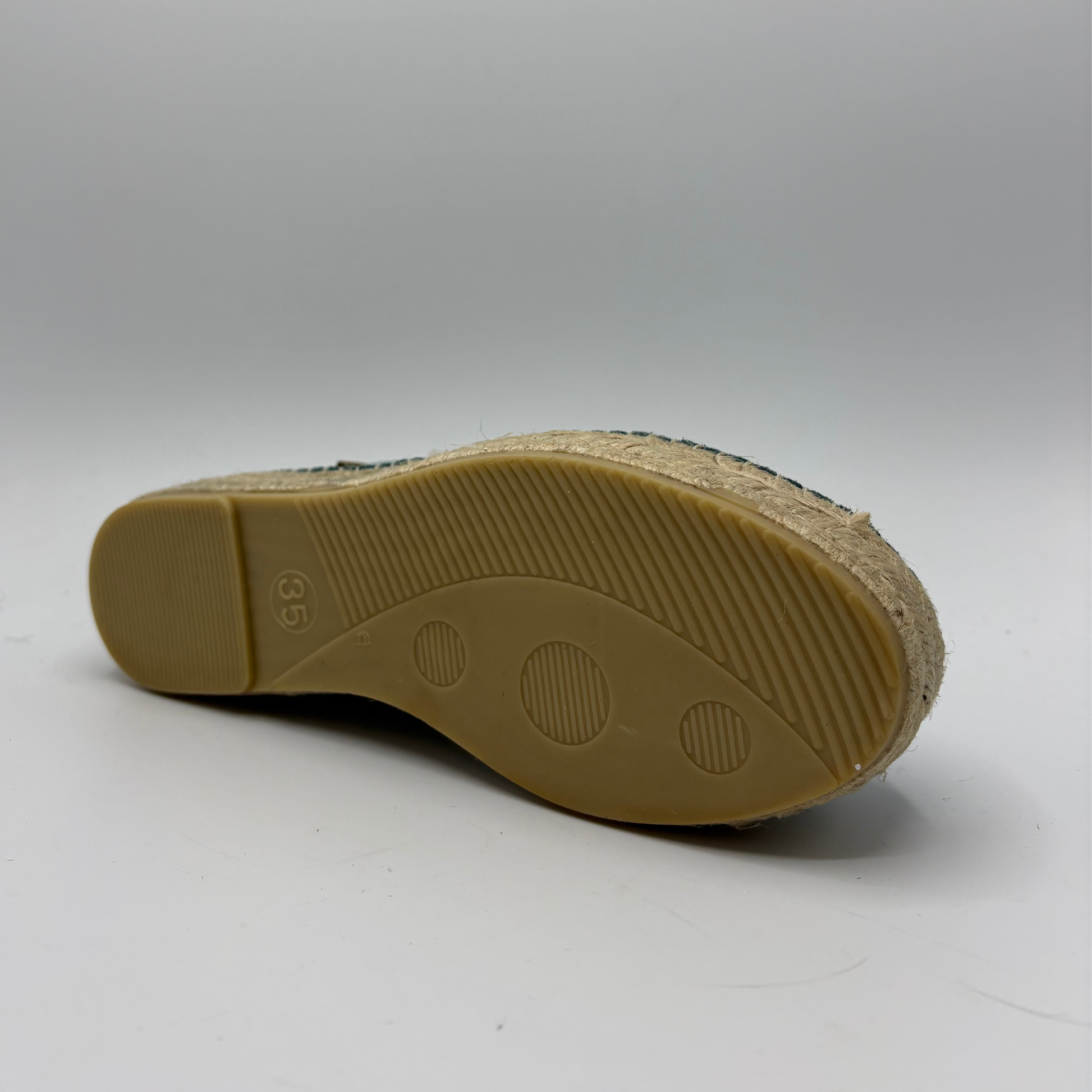 Tan shoe sole with brand logo on a white background