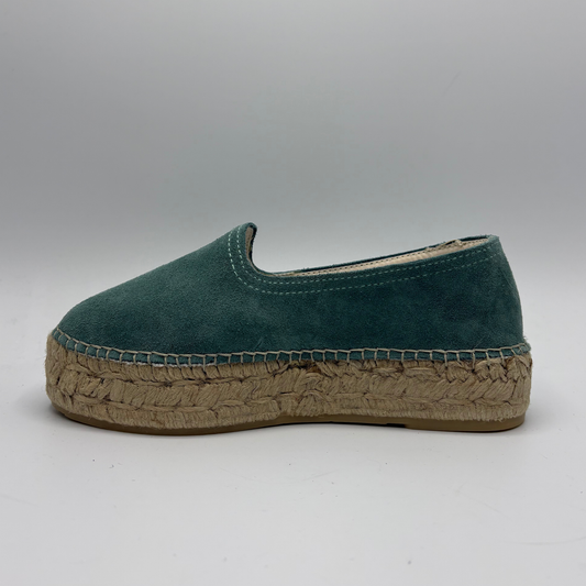 Green espadrille shoe on a gray background