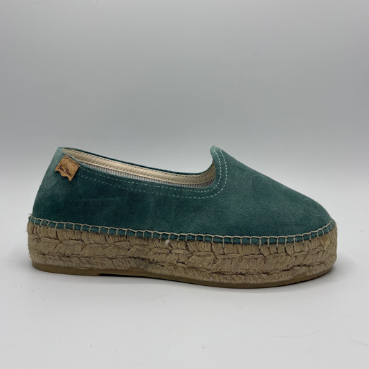 Green espadrille shoe on a gray background