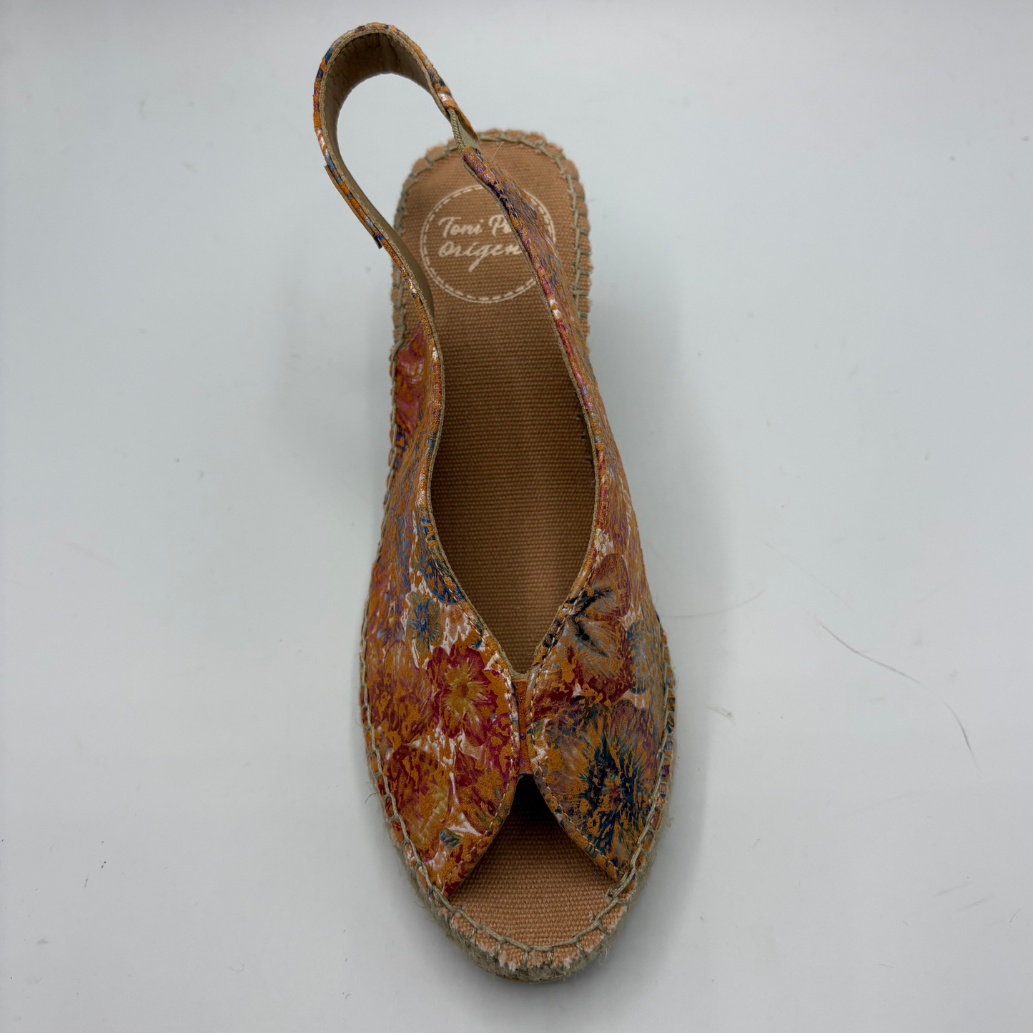Floral patterned sandal on a white background