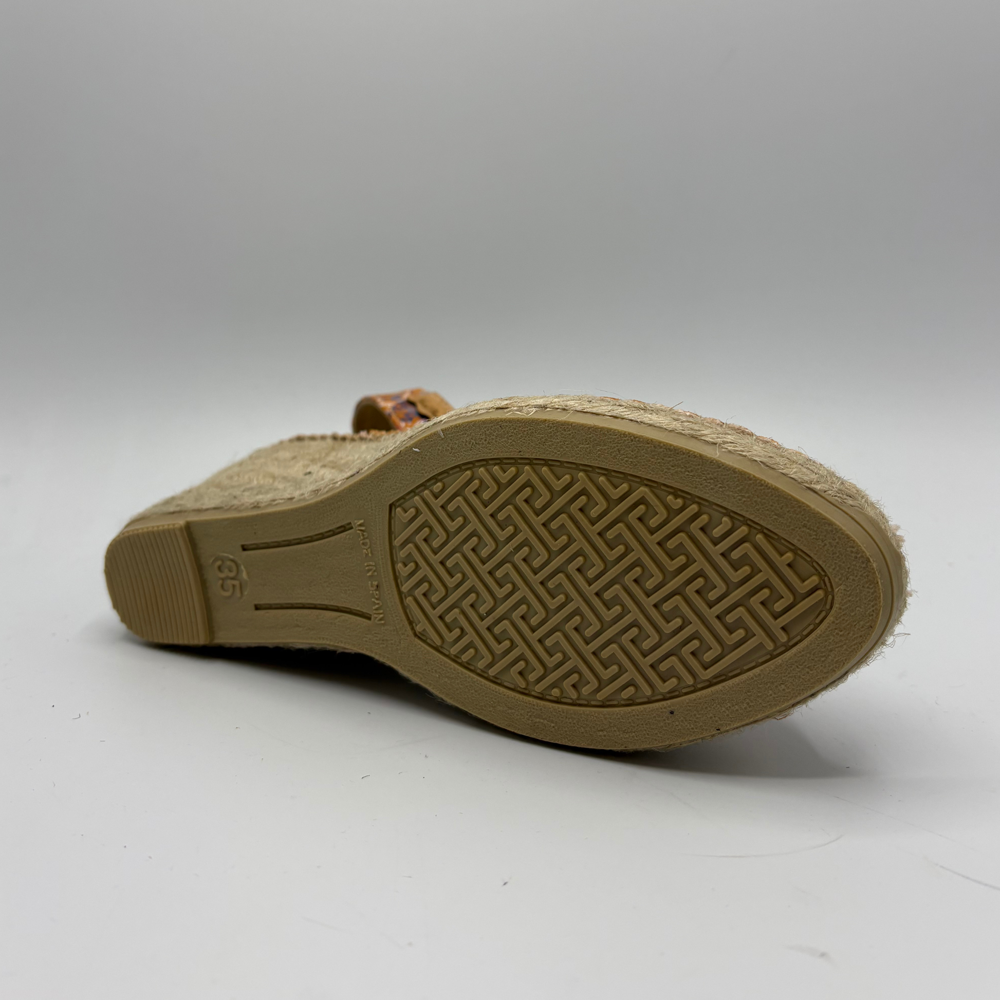 Brown sandal sole with textured pattern on a white background