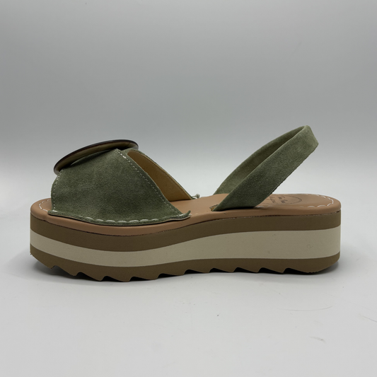 Green sandal with a brown platform sole on a white background