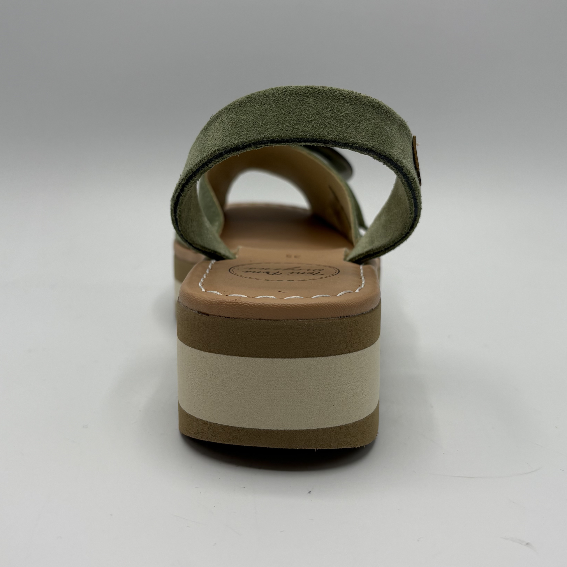 Green sandal with a brown and beige sole on a white background