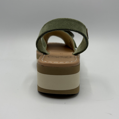 Green sandal with a brown and beige sole on a white background