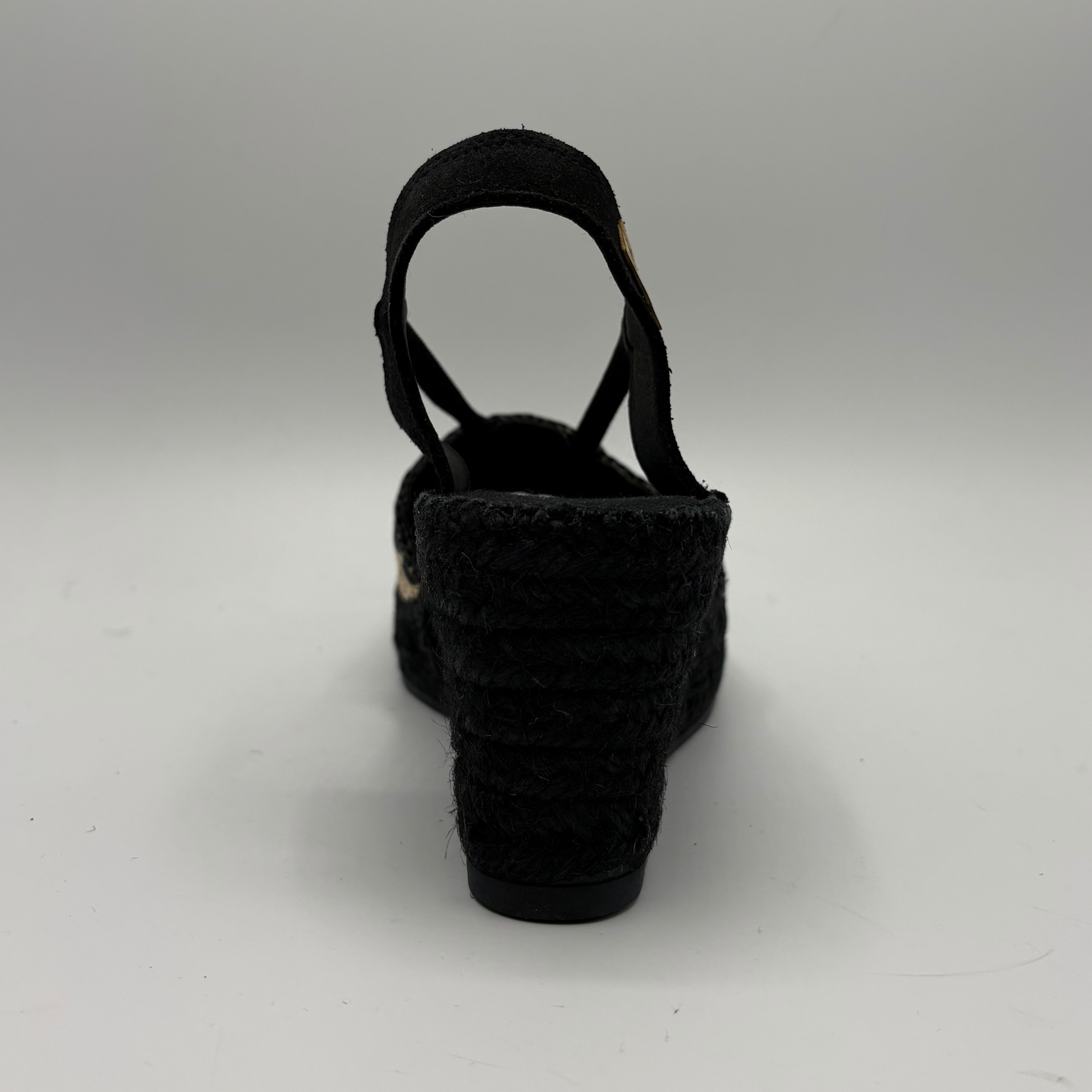 Black woven sandal on a white background