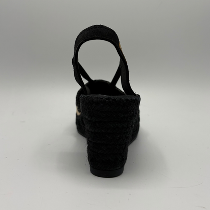 Black woven sandal on a white background