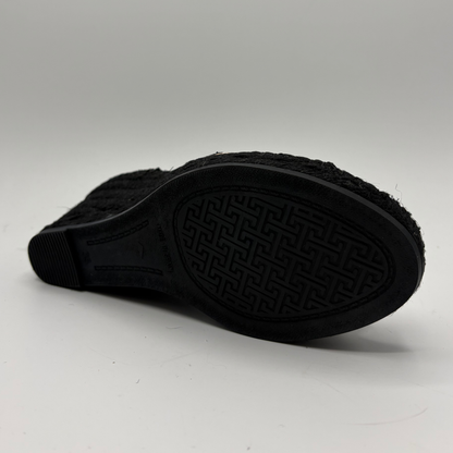 Black rubber sole of a shoe on a white background