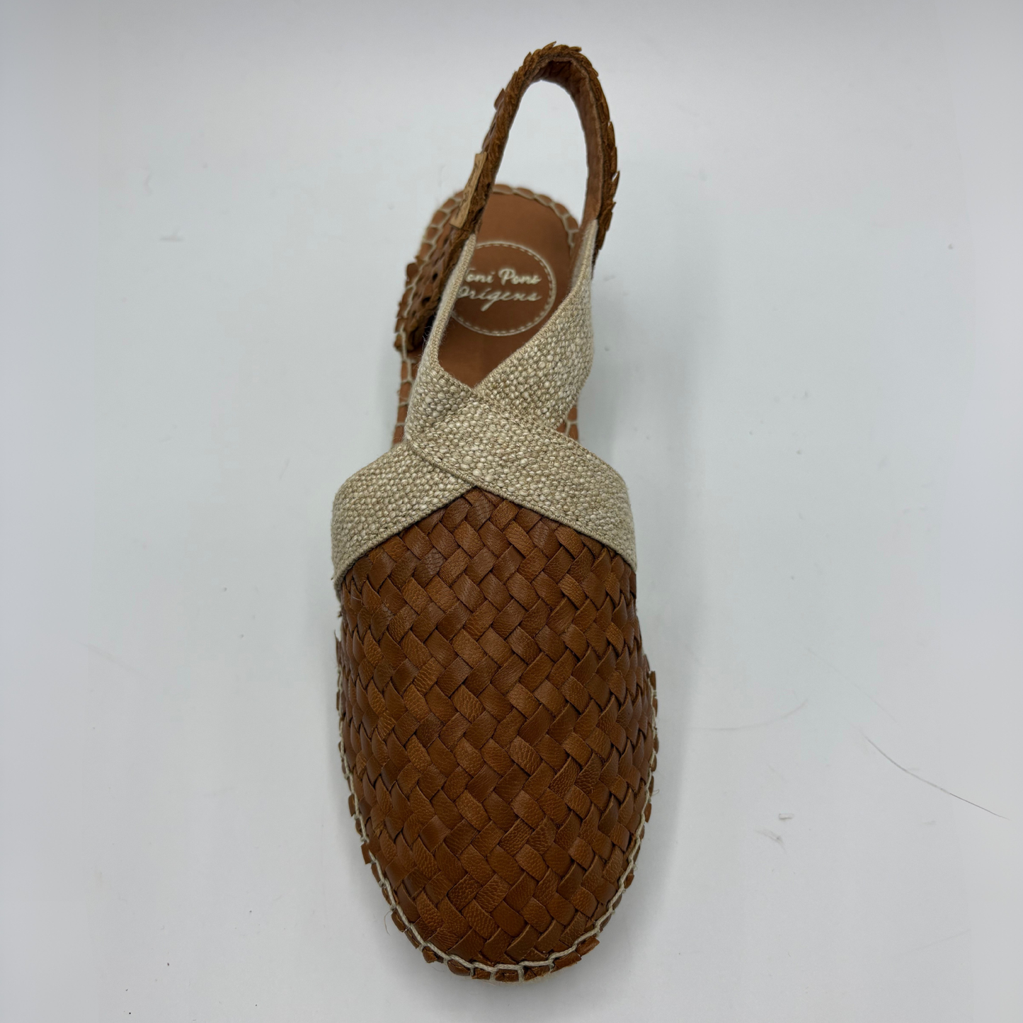 Brown woven sandal with beige straps on a white background