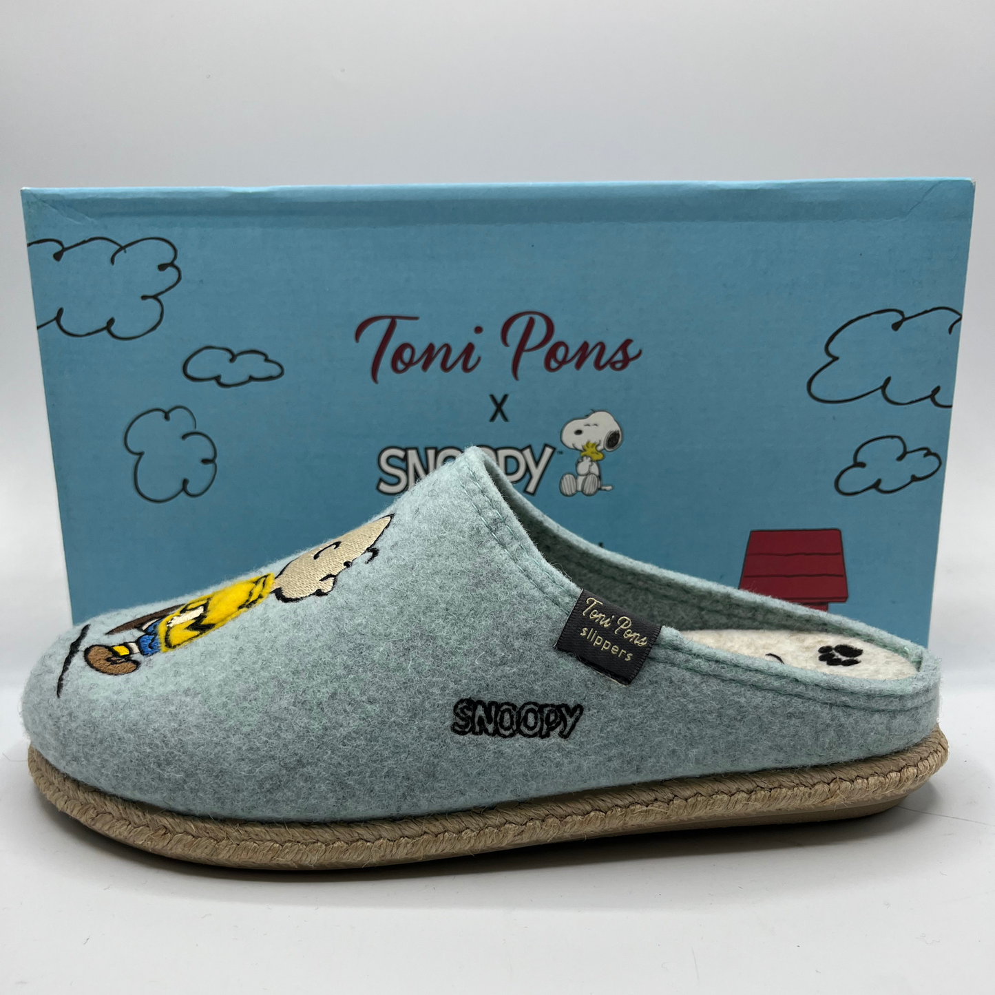 Blue slipper with Snoopy design and Toni Pons branding, against a blue background with Snoopy illustrations.