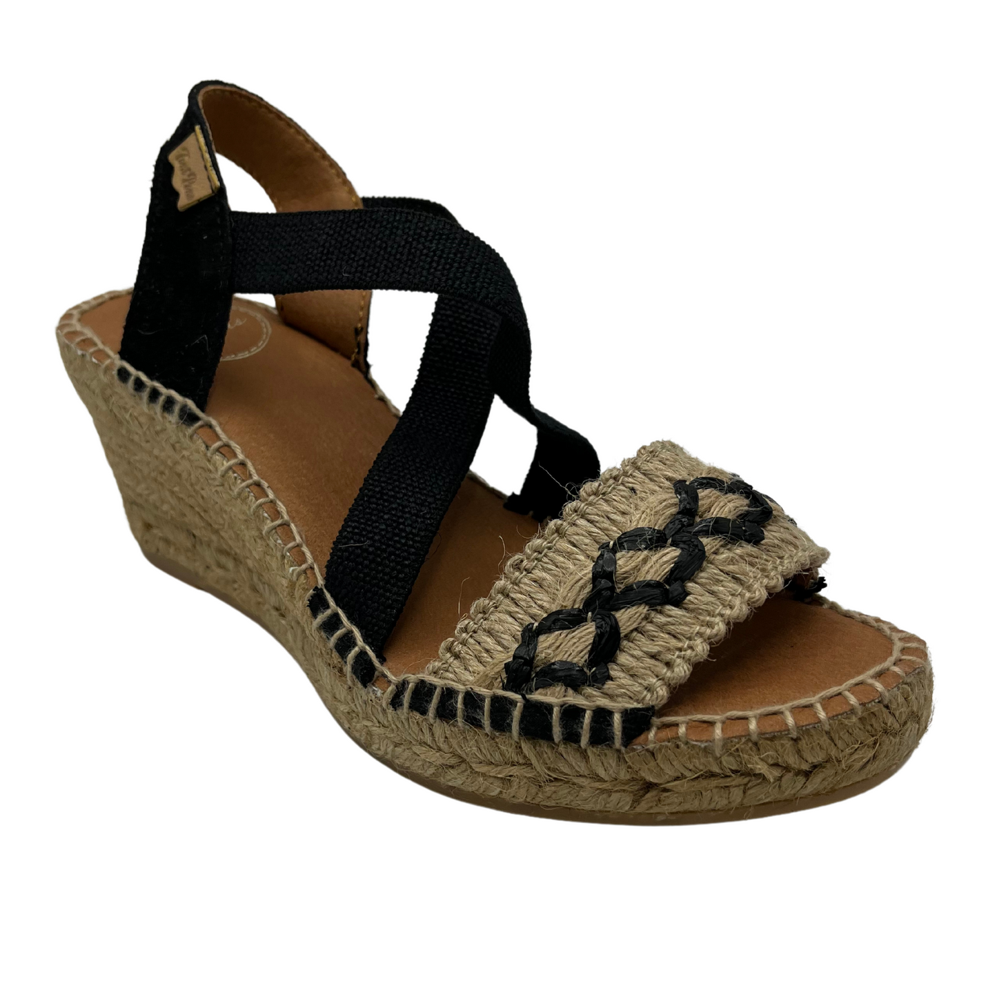 45 degree angled view of black and beige wedge sandal with X pattern across toe