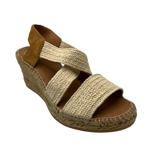 45 degree angled view of natural colour wedge heel with cross over straps and suede slingback heel strap