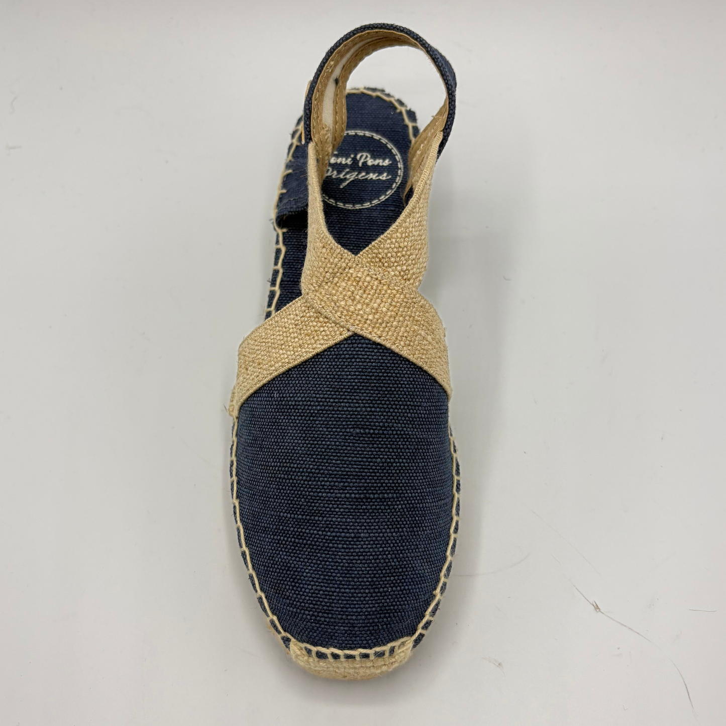 Blue espadrille shoe with jute strap on a white background