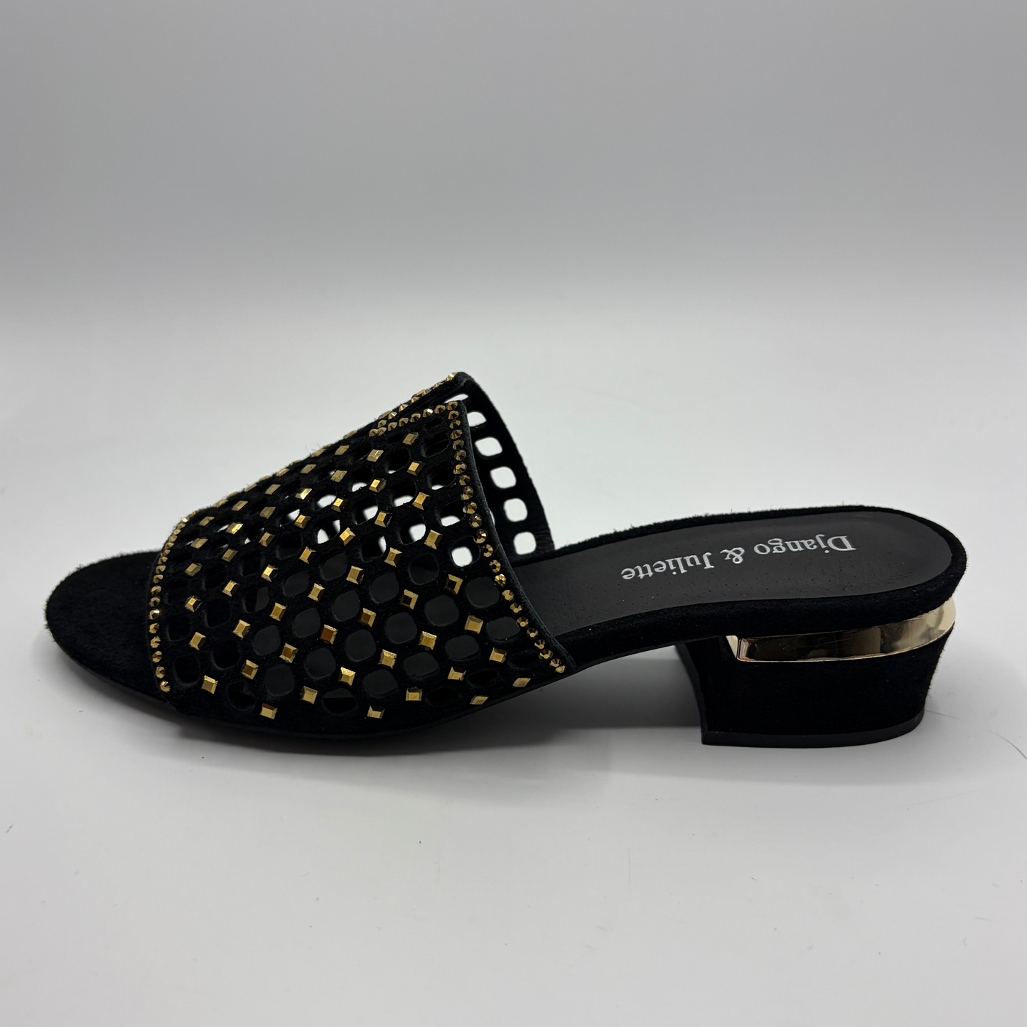 Black sandal with gold detailing on a white background