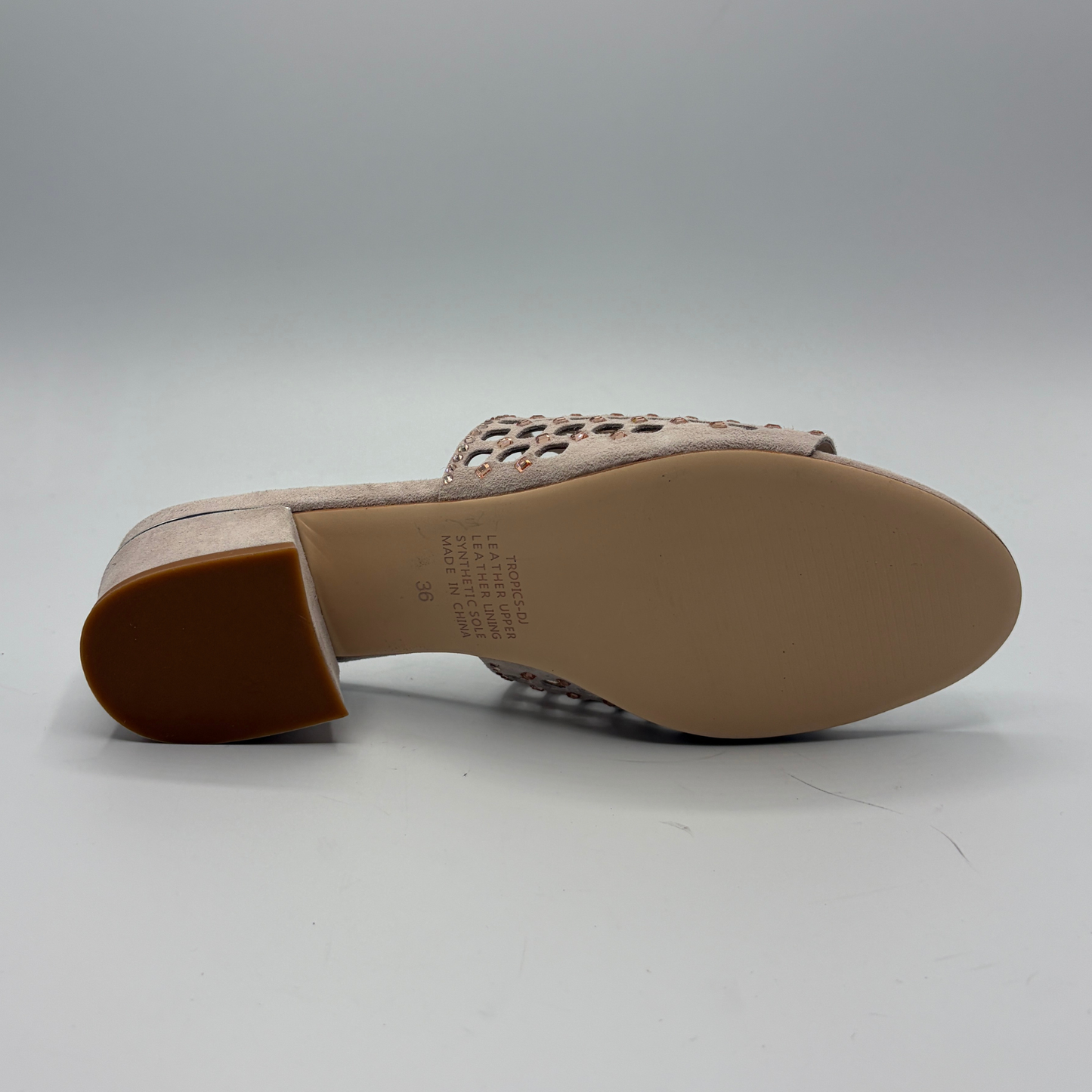 Beige sandal with cut-out design on a light gray background