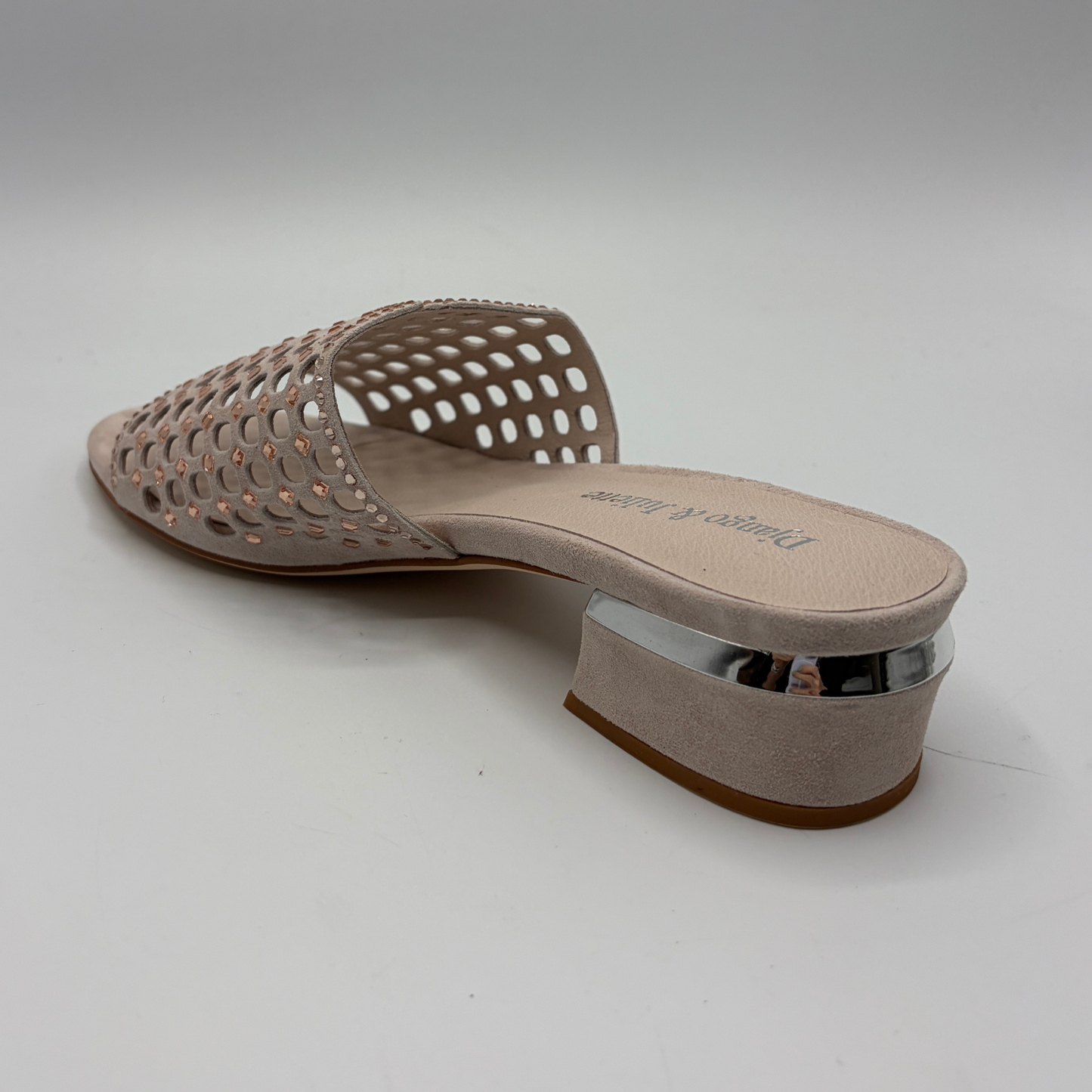 Nude sandal with openwork design on a light gray background