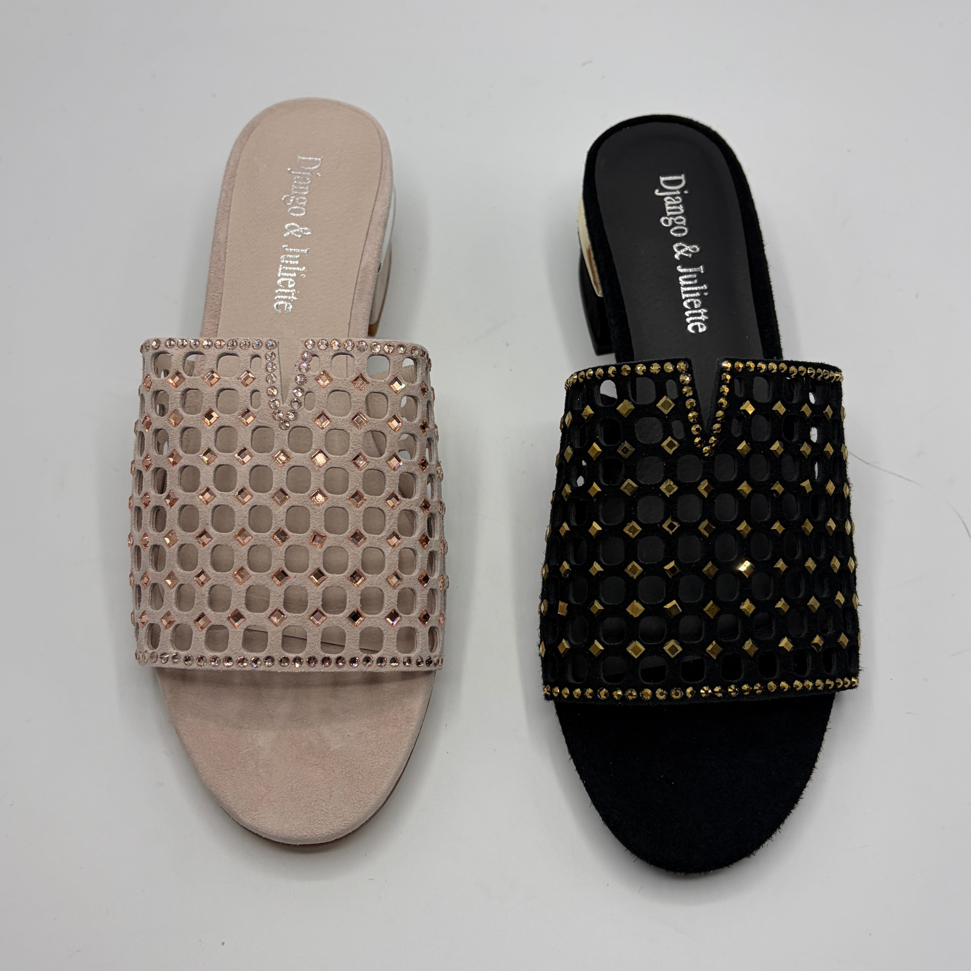 Pair of embellished slides from Django & Juliette on a light gray background