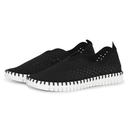 Black slip-on shoes with white sole on a white background