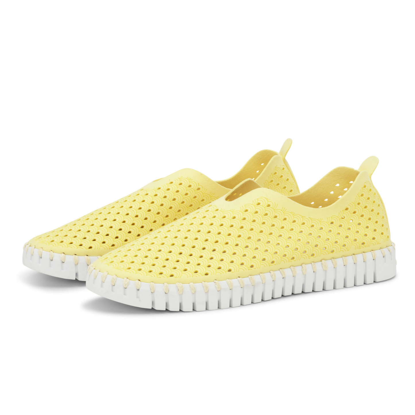 Angled view of a pair of yellow slip on shoes
