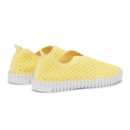 Yellow slip-on shoes with white sole on a white background