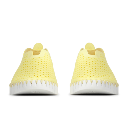 Yellow sneakers with white soles on a white background