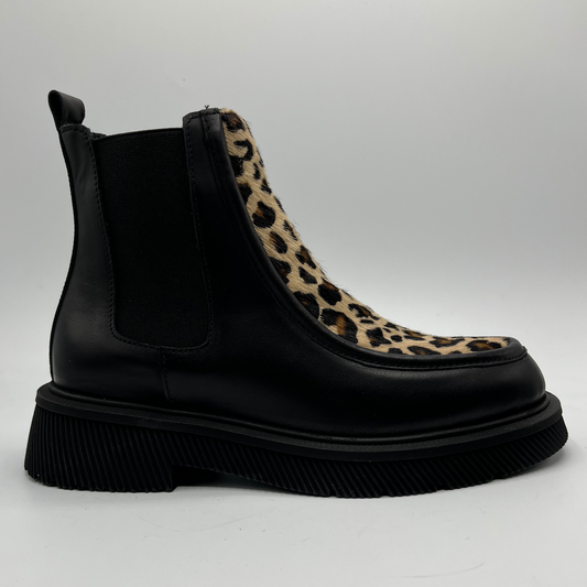 Black Chelsea boot with leopard print accent on a white background