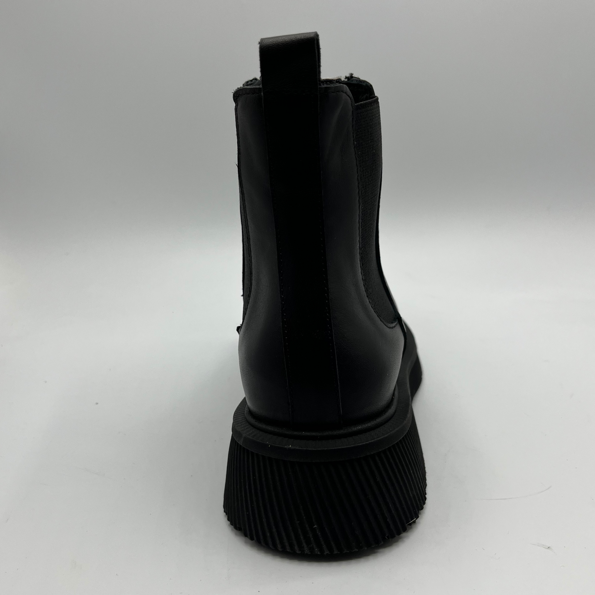 Black short boot with a chunky sole  on a white background